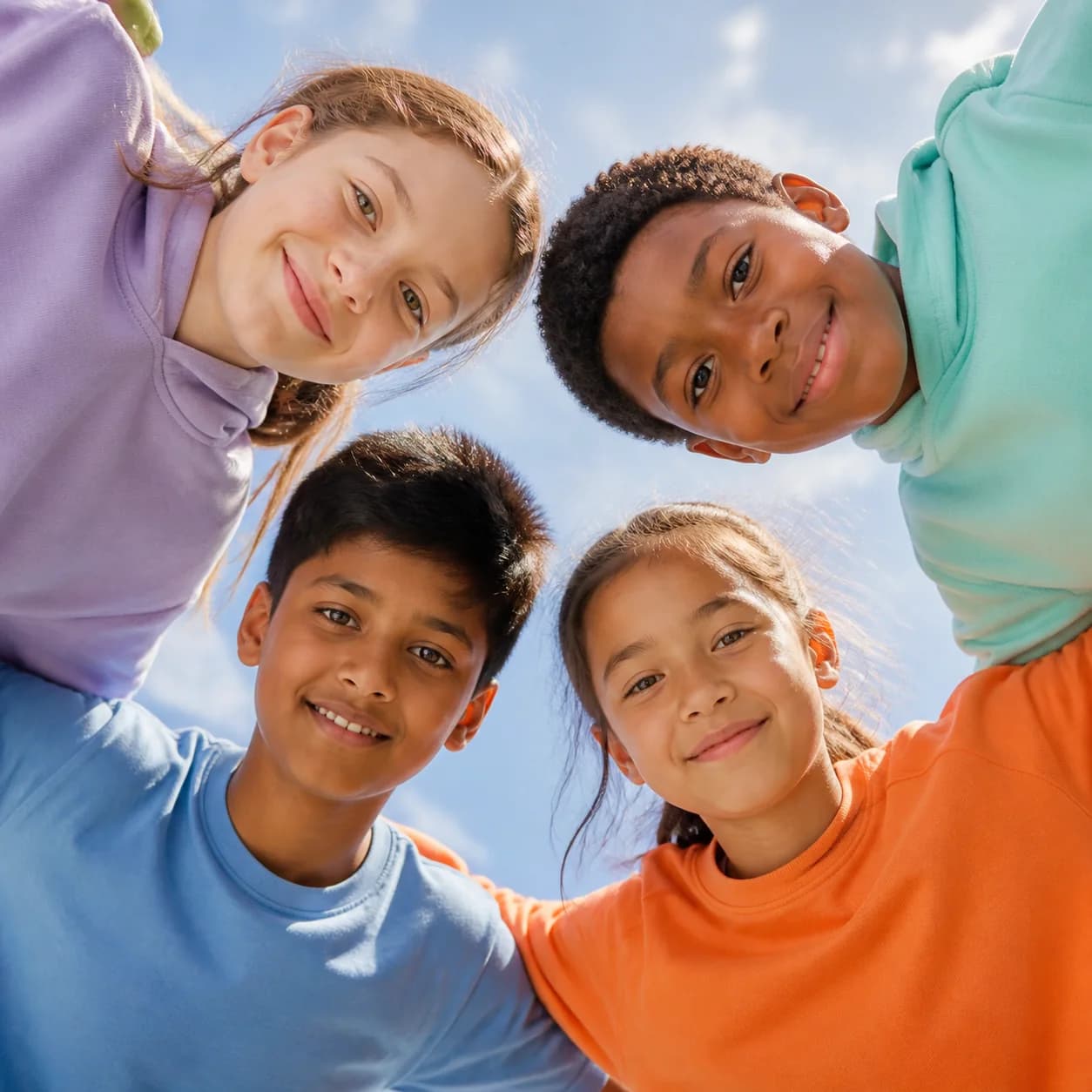 Four multicultural children learning together
